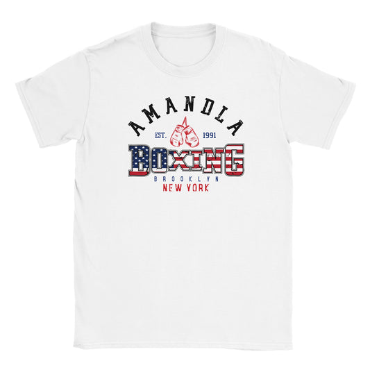 "Boxing-themed graphic on white shirt featuring red gloves, American flag patterned text reading 'Boxing', and location text 'Brooklyn, New York' with 'Amandla' above—representing strength, patriotism, and fight culture."

