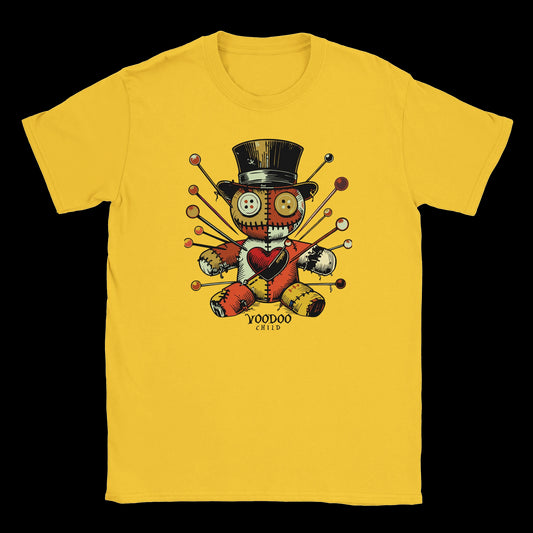Patchwork voodoo doll with buttons and pins wearing a top hat on yellow T-shirt
